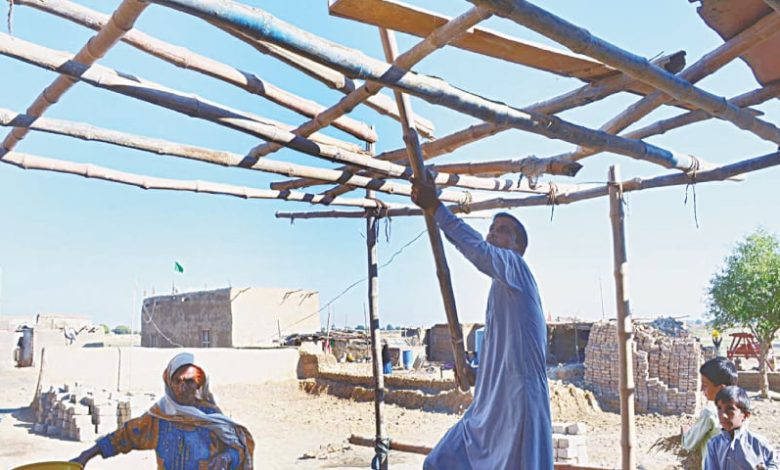 BAJARA A flood affected family reconstructing their house in UC Bajara.—Photos by Umair Ali