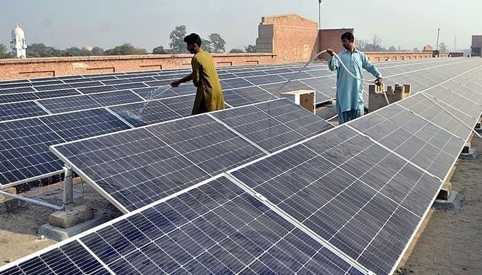 Workers washing solar PV